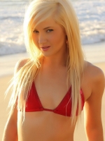 Blonde babe Ashlie teases at the beach in a skimpy red string bikini